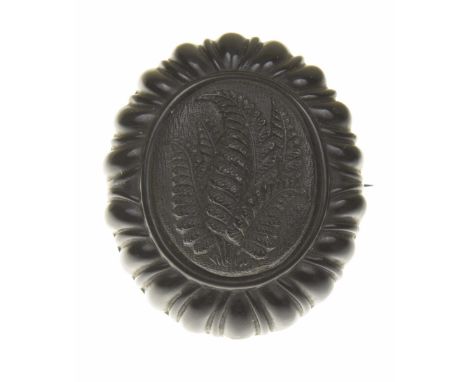 A Victorian jet broochOf oval outline, the raised frond carving within a lobed surround, length 4.2cm.Overall condition good 