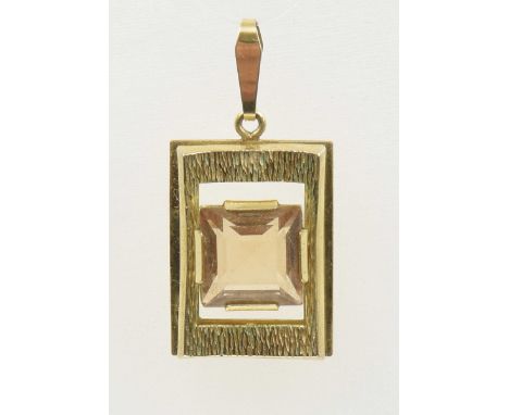 A 1970s orange paste pendantThe square shape orange paste within a rectangular shape textured surround, stamped 14ct, length 