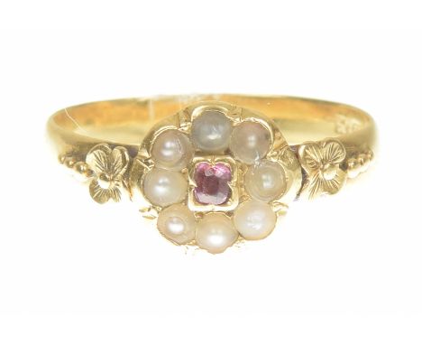 A mid Victorian 22ct gold ruby and split pearl cluster ringOf floral design, the cushion shape ruby within a split pearl scal