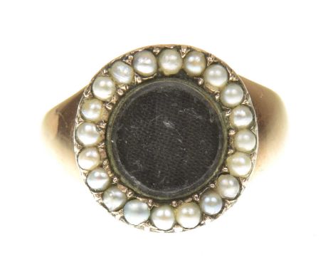 An early 20th Century split pearl memorial ringThe circular glazed vacant panel within a split pearl surround and tapered sho