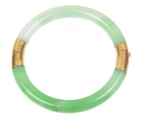 A jade bangleDesigned as two semi-circular jade pieces, with polished push piece clasp and hinge, inner diameter 6cm.Overall 