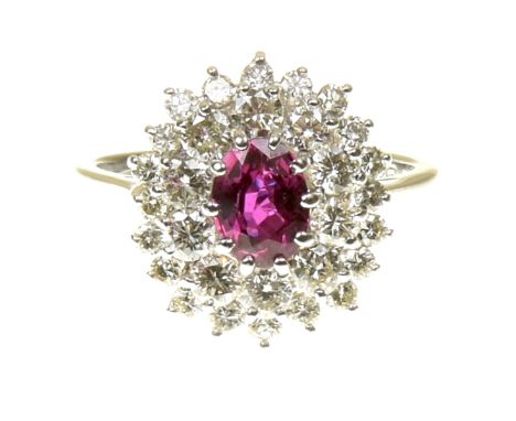 A ruby and diamond cluster ringThe oval shape ruby within a brilliant cut diamond tiered surround, estimated total diamond we