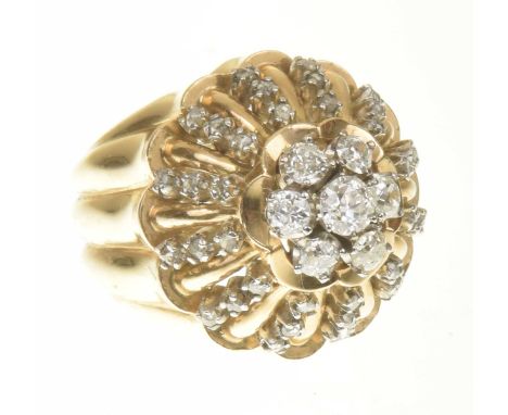 An 18ct gold diamond dome ringThe old cut diamond floral cluster, atop the rose cut diamond openwork dome and scalloped surro