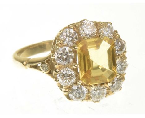 A sapphire and diamond cluster ringThe rectangular shape yellow sapphire within a brilliant cut diamond surround, stamped 18c