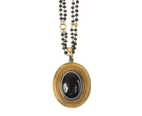 A banded agate locketThe oval banded agate cabochon within a cannetille  and ridged surround, with glazed panel reverse, susp