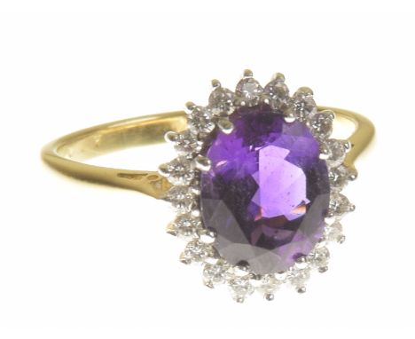 An 18ct gold amethyst and diamond cluster ringThe oval shape amethyst within a brilliant cut diamond surround, estimated tota