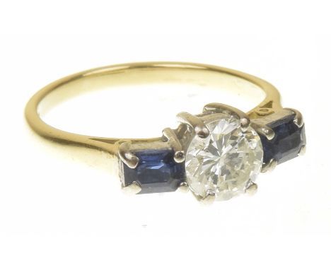 An 18ct gold diamond and sapphire three stone ringThe brilliant cut diamond with rectangular shape sapphire sides, estimated 