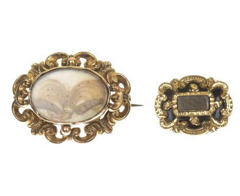 Two late Victorian memorial broochesThe first designed as an oval shape glazed hair and split pearl panel within a scrolling 