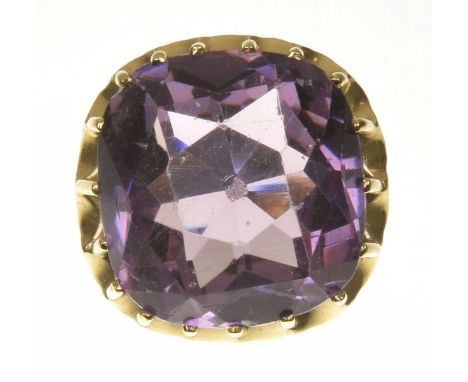 An amethyst dress ringThe cushion shape amethyst with an undulating surround, ring size F1/2, weight approx. 14.3g.Overall co