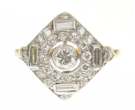 A diamond dress ringThe brilliant cut diamond collet within a pavé set diamond kite shape surround, and baguette cut diamond 