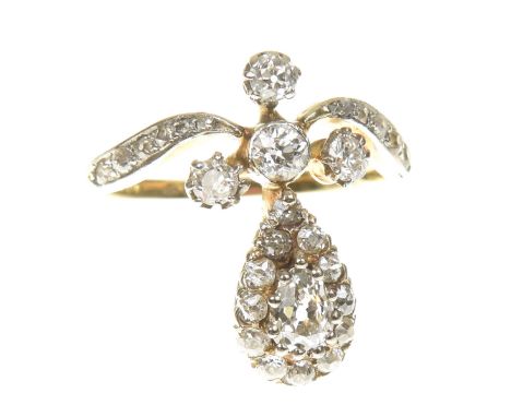 A late 19th Century diamond dress ringDesigned as a pear shape diamond cluster, with old cut diamond trefoil cap and scrollin