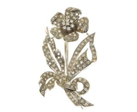 A diamond floral broochThe brilliant cut diamond cluster, within a single cut diamond petal surround, to the similarly cut di