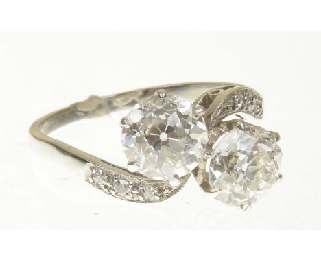 A mid 20th Century diamond crossover ringThe old cut diamond duo with scrolling similarly cut diamond shoulders, estimated to
