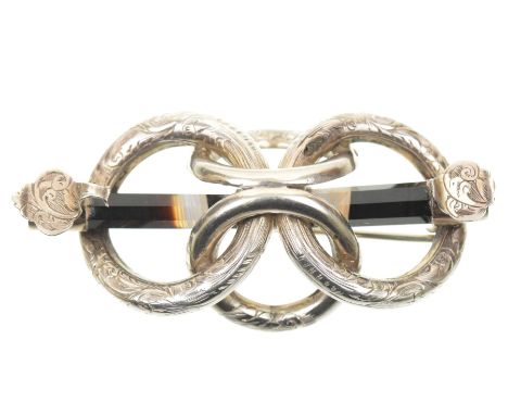 A mid Victorian banded agate broochDesigned as an octagonal banded agate bar, with scrolling terminals, and interlocking hoop