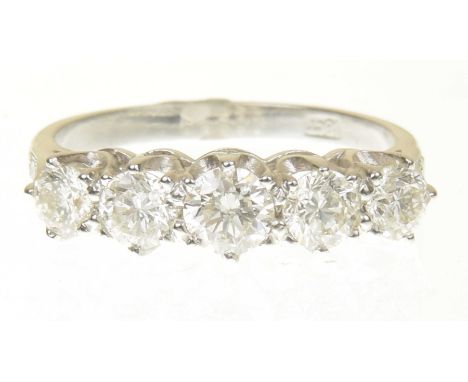 A diamond five stone ringDesigned as a brilliant cut diamond line, with similarly cut diamond tapered shoulders, stamped 18ct