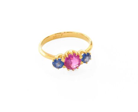 A Synthetic Sapphire Dress Ring, the round cut synthetic pink sapphire flanked by round cut synthetic blue sapphires, in yell