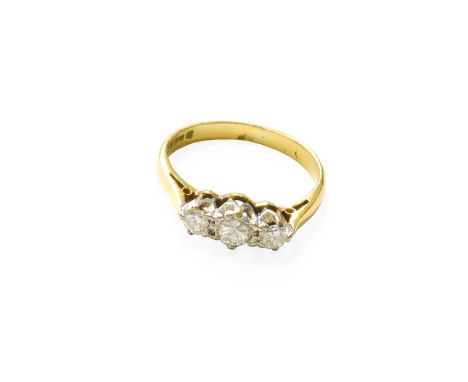 An 18 Carat Gold Diamond Three Stone Ring, the graduated round brilliant cut diamonds in white claw settings, to a yellow tap