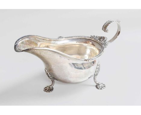 A George V Silver Sauceboat, by Walker and Hall, Sheffield, 1930, in the George III-style, oval and with foliage, shell and p