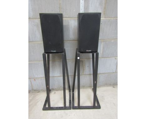 A pair of Mission bookshelf speakers and a pair of speaker stands 