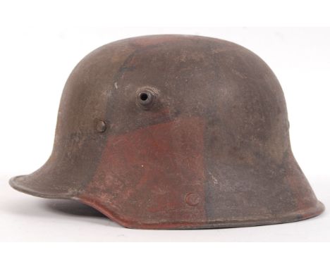 An original rare Imperial German WWI First World War M16 pattern Camouflaged Steel combat helmet. Fine untouched example of a