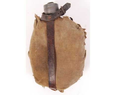 A rare WWI First World War German soldier's / infantry water bottle. Complete with tan canvas covering, with leather strappin