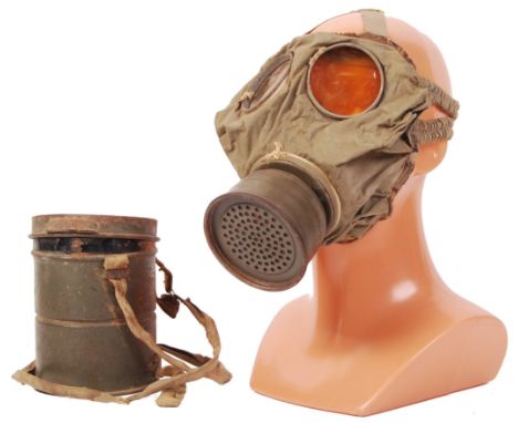An incredibly rare WWI First World War German infantry soldier's Gas Mask and carry tin. Early issue green canvas mask, with 