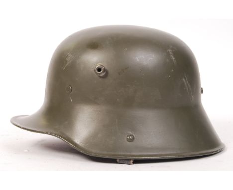 An original WWI First World War German infantry M16 pattern steel combat helmet. Restored - repainted, with a reproduction li