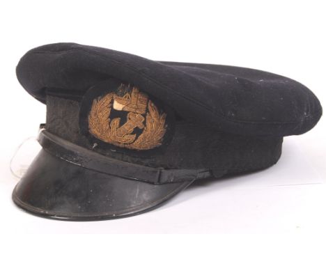 An early 20th century Naval officer's peaked cap. Label to interior reads ' D.33 First Officer Rogers, 7 '. D.33 is presumed 