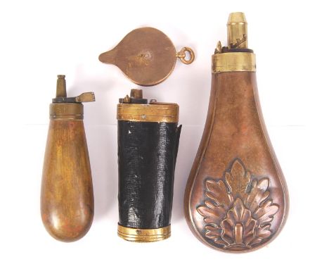 A collection of antique 19th century powder shot flasks and related items. Comprising of a copper floral motif powder shot fl