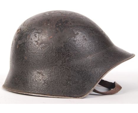An original WWI First World War Swiss M-1918 pattern steel uniform helmet. Retains the original leather chin strap and has be