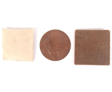 A WWI First World War death penny / plaque for a ' Phillip Davies '. Within its original paper envelope and cardboard sleeve.
