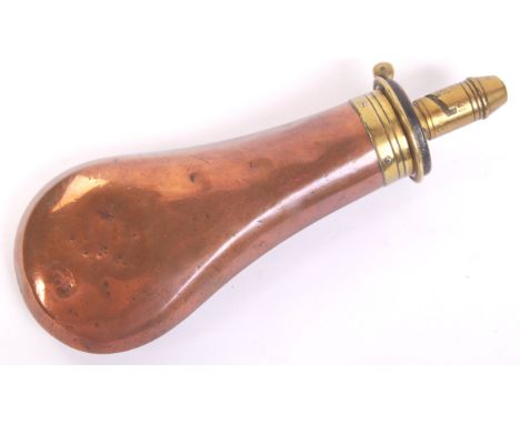 A 19th century " Sykes Patent " powder shot flask. The copper baluster body with brass mount and sprung mechanism. The brass 