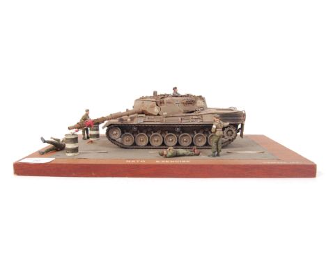 A superb museum quality military model diorama. Showing a military vehicle, titled ' Nato Exercise '. The model being superbl