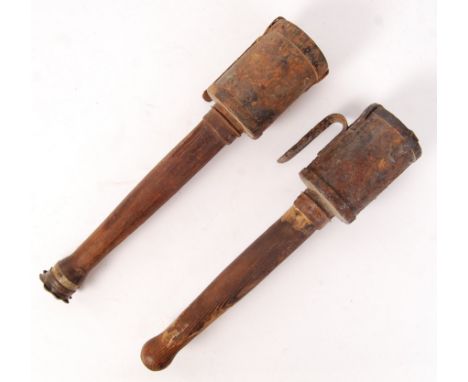 Two scarce WWI First World War German stick grenades. Both with wooden handles and steel screw-on tops. Various markings to t