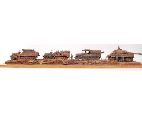 A superb museum quality military model diorama. Showing armoured troop carriers towing a Tiger Tank , titled ' Towing A Tiger