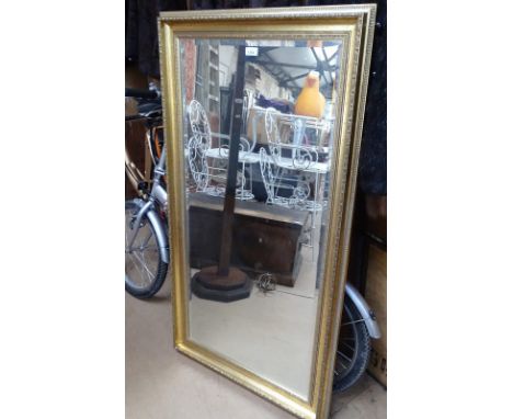 A modern gilt framed rectangular bevelled edge wall mirror.