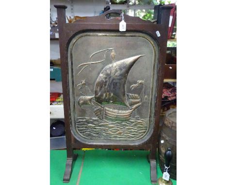 Embossed copper ship design firescreen in oak surround.