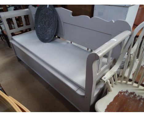 A continental grey painted settle with rising seat and panelled back, length 6', back height 3'4".