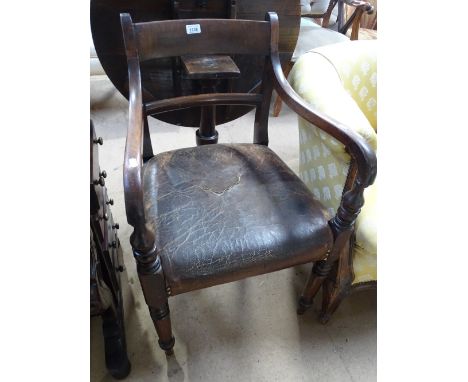 A Georgian mahogany desk chair with leather upholstered seat.