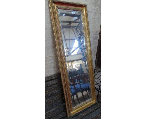 A modern gilt framed bevelled edge rectangular wall mirror.