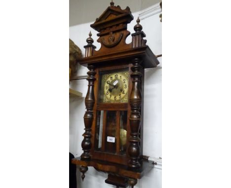 A carved mahogany cased wall clock with 2-train movement.
