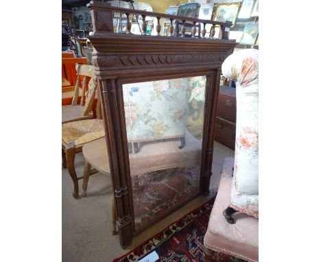 A French carved oak hanging wall mirror with turned columns, width 2'11".
