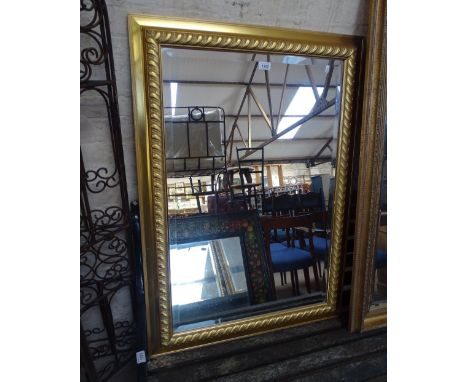 A modern gilt framed bevelled edge rectangular wall mirror.