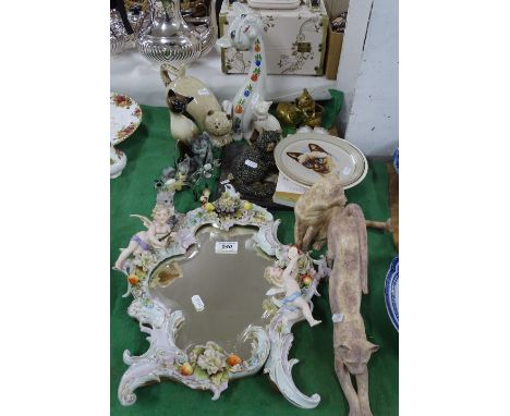 Various cat figures and a mirror.
