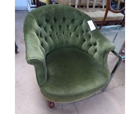 A Victorian button back upholstered bow armchair with turned mahogany feet.