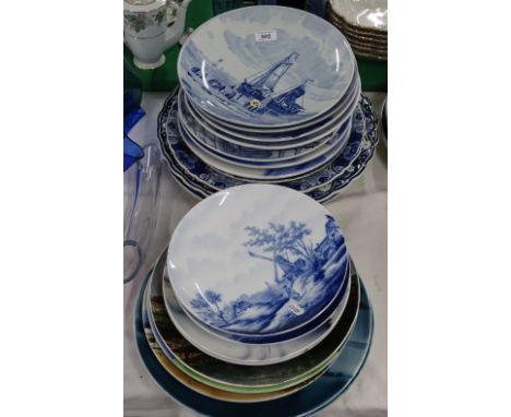 Various Delft blue and white chargers and plates.