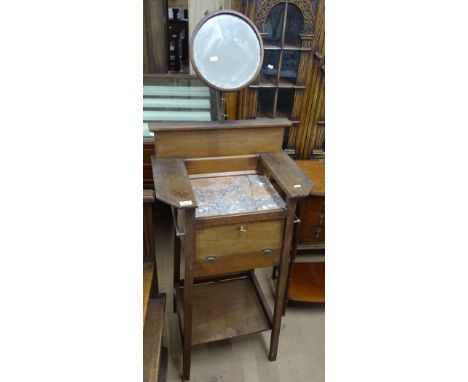 An Arts & Crafts mahogany shaving stand, with telescopic mirror, marble top and cupboard under on splayed legs, stand height 