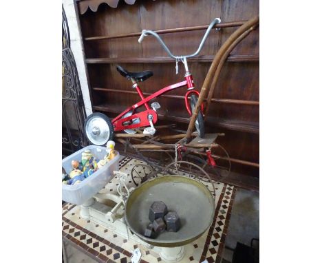 A child's Trike, painted ceramic figures, grocer's scales.