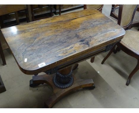 A Regency rosewood foldover card table, carved fluted centre column and platform base, width 2'9".