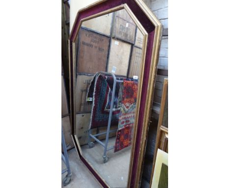 A large gilt and velvet framed shaped wall mirror, length 6'2", width 4'3"